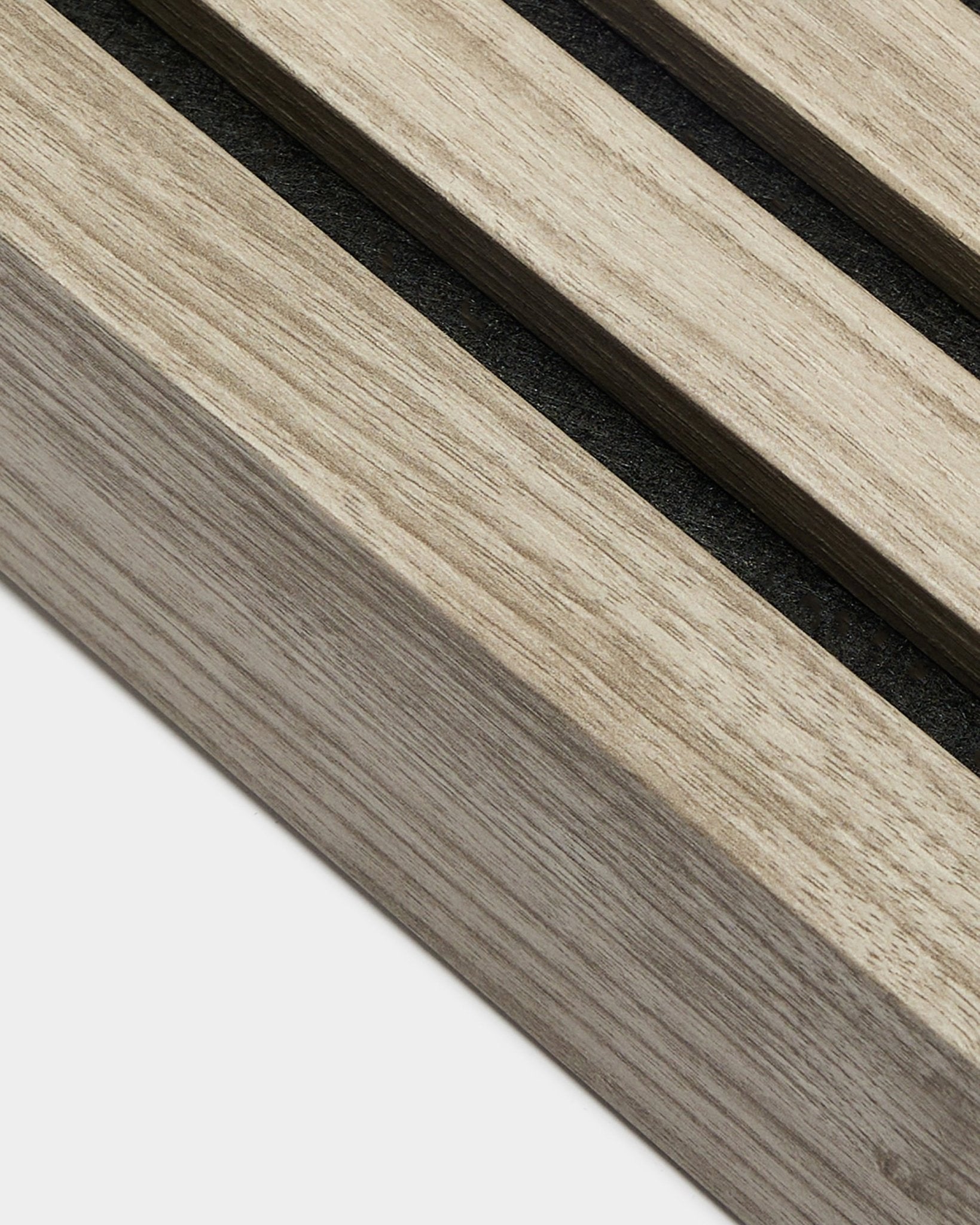 Primo piano della lamella terminale WoodUpp in Weathered Rovere, larga 6,7 cm, con doghe acustiche in legno parallele e spazi black, della gamma Prodotti per l’installazione.