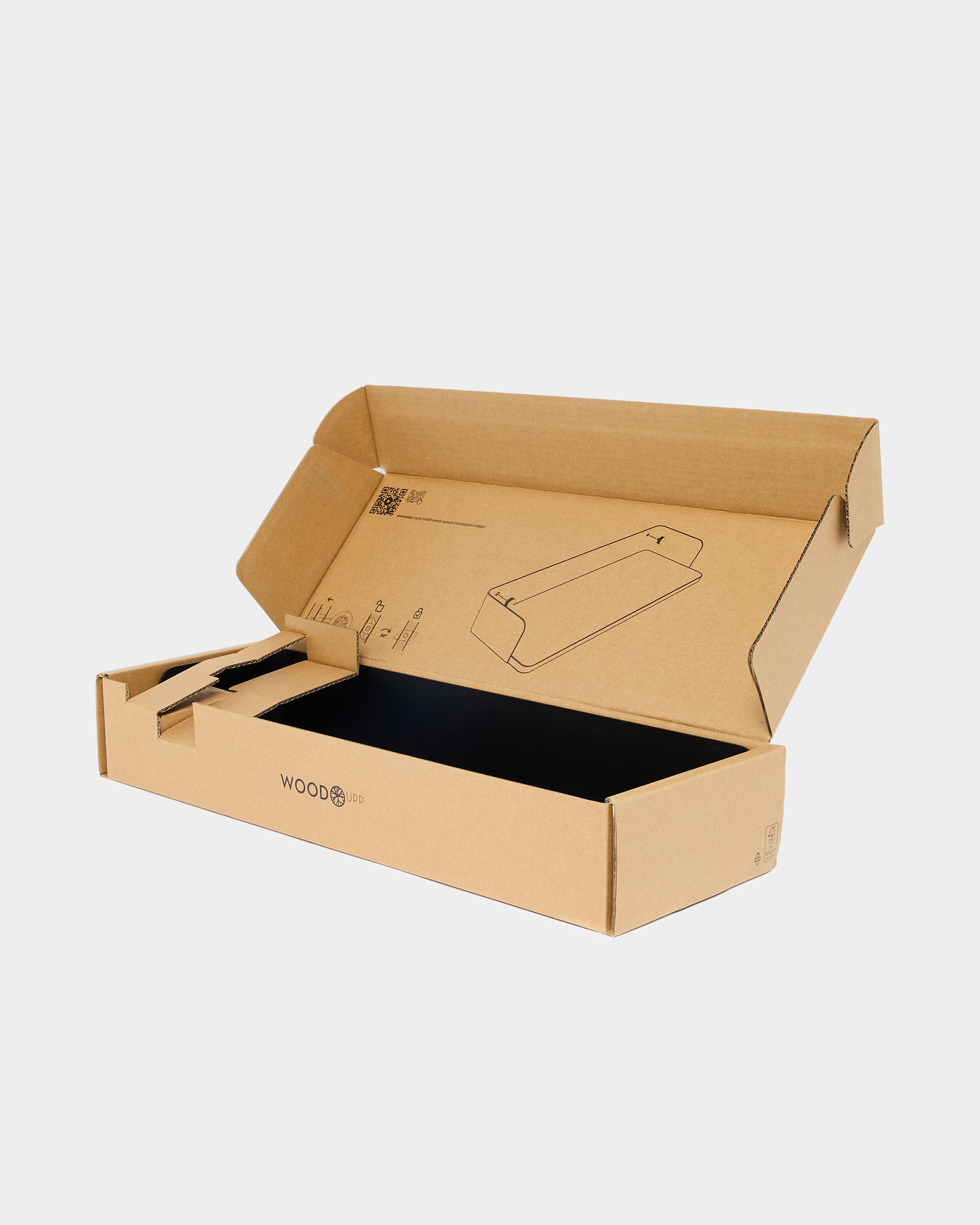 Open cardboard box with black interior, foldable flaps, and a simple line illustration on the inside lid; WoodUpp branding printed on the front.